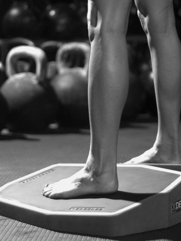 A lower leg standing on the XDECK, the ankle, knee and hip stacked vertically